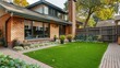 Charm of a Suburban Home Featuring a Pristine Artificial Lawn, Artistic Brick Walls, and Large Windows