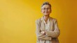 medium shot of a caucasian older woman standing and smiling against yellow background , modern office cinematic realism  