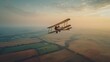 Classic Biplane Flight Over Countryside at Sunset. The sunset paints the sky as a classic biplane flies low over the patchwork fields of the countryside, offering a serene end to the day.
