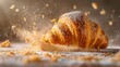 A flaky, buttery croissant being torn apart, with crumbs flying