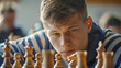 A young man intensely concentrating during a challenging game of chess