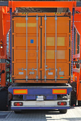 Wall Mural - Lifting Orange Shipping Container From Cargo Truck Trailer