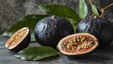   A pair of figs resting atop a table beside a lush green plant and a juicy piece of fruit
