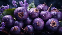   A Group Of Purple Fruits Placed Atop A Mound Of Green Leaves, With Droplets Of Water Sprinkled On A Dark Background