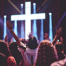 Christian Worshipers With Raised Hands In Front Of A Cross During A Fervent Worship Service.