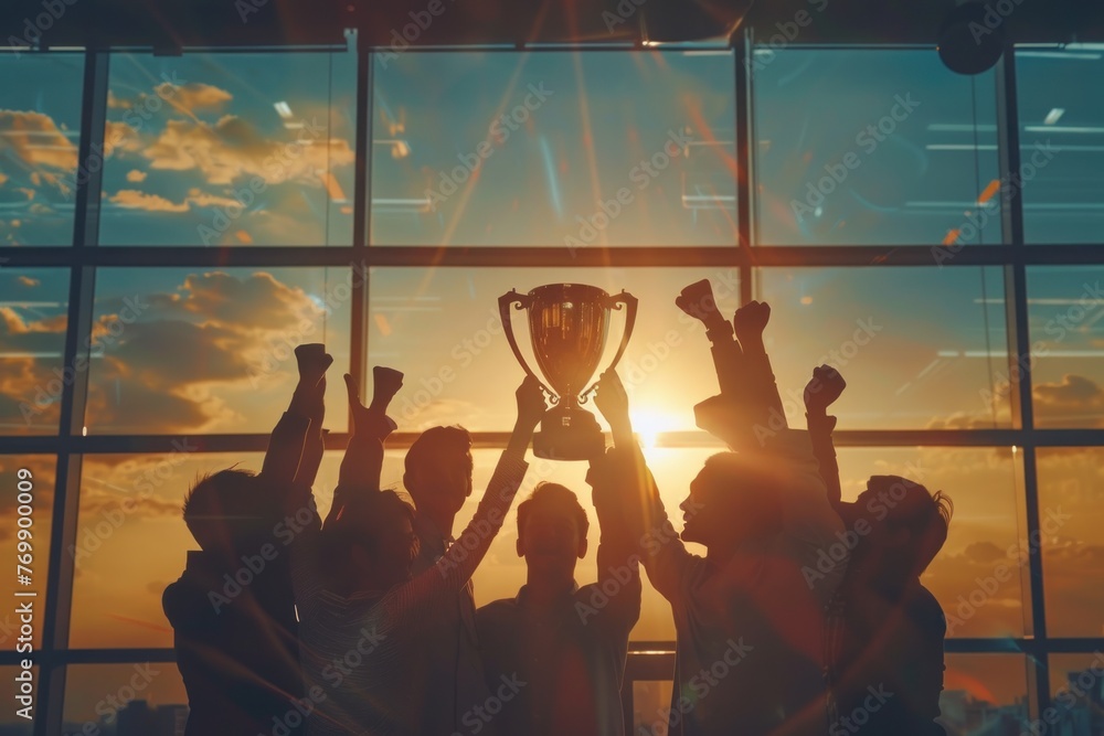 Happy worker team in office holding a golden trophy to celebrate ...