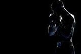 Fototapeta  - silhouette Angry MMA man fighter stand wearing boxing gloves on a black background