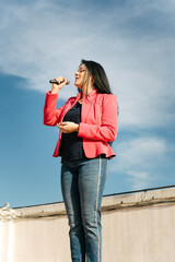 Pop singer singing with a microphone on the roof