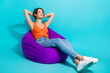 © deagreez - Full length photo of good mood adorable woman dressed knit singlet chill on pouf palms behind head isolated on turquoise color background