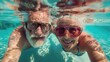 © Katsiaryna - Happy senior couple having fun in the swimming pool. Retirement lifestyle and people concept.