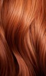 Extreme close-up shot of hair texture, with slight curves brown with copper highlights
