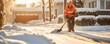 Man using snow shovel to clear snow from roads in winter