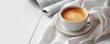 Cup of coffee in white cup on table with white blanket. Coffee theme. copy space for your text