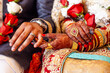 Muslim bride and groom holding hands during ceremony