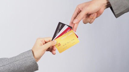 Wall Mural - Hands are sent and receive credit cards on white background.