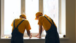 © DenisProduction.com - Workers studying the draft of a house. Builders are prepare plan of a large apartment.