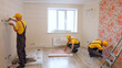 © DenisProduction.com - Team of builders make repairs living room. Renovated apartment.