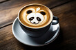 Cup of coffee with latte art, milk foam panda bear illustration. Cup of handcrafted cappuccino on wooden table for coffee lovers. Cozy atmosphere.