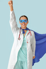 Poster - Beautiful female doctor dressed as super hero on blue background