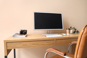 Poster - Stylish workplace with modern computer and cup of coffee near color wall