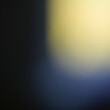 One light-yellow spot in the blue frame, an abstract blurry background.