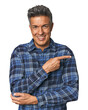 © Asier - Middle-aged Latino man smiling cheerfully pointing with forefinger away.