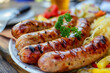 Grilled Bratwurst meat sausages with herbs and spices. German cuisine.