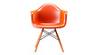 An orange plastic chair with wooden legs basking in the sunlight