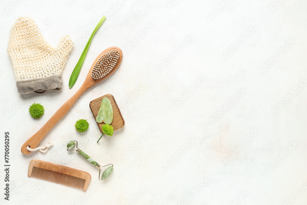 Composition with spa supplies and flowers on light background