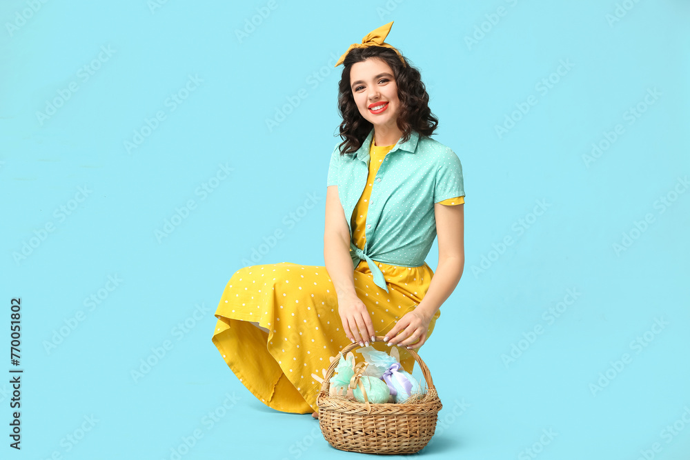 Beautiful pin-up woman with Easter basket on color background