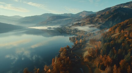 Poster -  Aerial view of a lake surrounded by trees, with mountains in the distance and foggy atmosphere