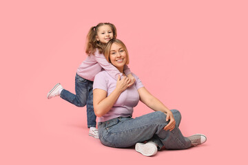 Sticker - Mother playing with her daughter on pink background. Mother's Day