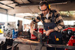 © Zamrznuti tonovi - Dedicated worker wields his grinder while making a metal construction.