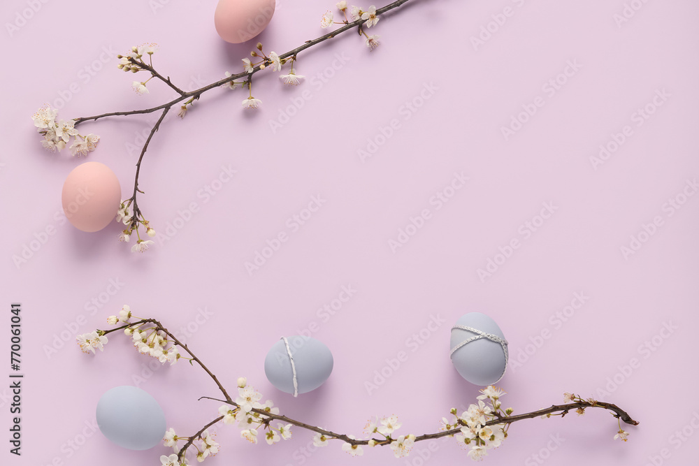 Easter eggs and blooming branches on lilac background. Top view