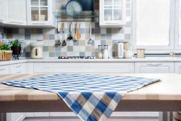 Aufkleber - Modern kitchen setting with a blue and white checkered tablecloth on a wooden table, blurred background. High quality photo