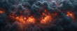 Intense flames peak through billowing dark smoke in a dramatic display of fire's destructive power.	
