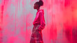 Artistic photo of a black girl dressed in trendy oversized pants and an oversized hoodie with painted pink wall on background