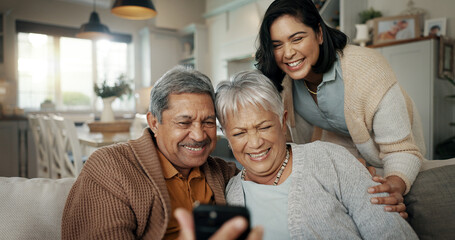 Wall Mural - Video call, living room and woman with elderly parents on a sofa relaxing and talking on a phone. Smile, bonding and female person with senior people on virtual conversation with cellphone at home.