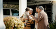© peopleimages.com - Family, welcome and hug outdoor of home in backyard with mother, grandparents and child with love and care. Reunion, woman and kid visit parents, travel and surprise for holiday with embrace or joy