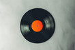 © Igor - Black and Orange Vinyl Record on White Background