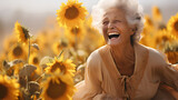 Fototapeta Perspektywa 3d - a smiling elder woman laughing while being among sunflowers