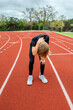 © 3Days2Go Media - Youth male track runner bent over exhausted after a race
