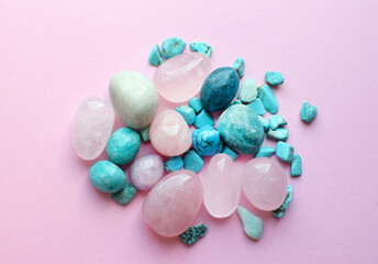 Wall Mural - Round rose quartz crystals and turquoise stones on a pink background. Healing crystals.