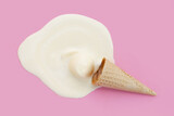 Fototapeta Sypialnia - Melting ice cream ball with waffle cone on pink background.