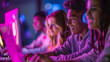 © Alina Tymofieieva - Students looking to a laptop smiling neon lights