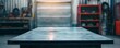 Blank rough metal workshop and desk table surface on blurred garage background with copy space, Empty space for your products and crafty idea in man cave studio.