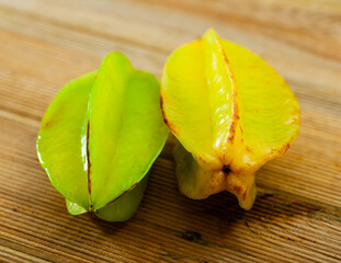 Wall Mural - Closeup of whole ripe star fruits (carambola) on wooden surface. Healthy vitamin product