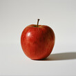A rustic-looking apple with a richly textured skin presented against a neutral-toned background, highlighting organic imperfections