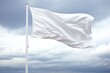 A white flag is flying in the sky on a cloudy day. The flag is large and white, and it is blowing in the wind. The sky is overcast, and the clouds are low and dark