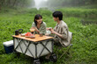 © Blue Jean Images - Young couple picnicking outdoors